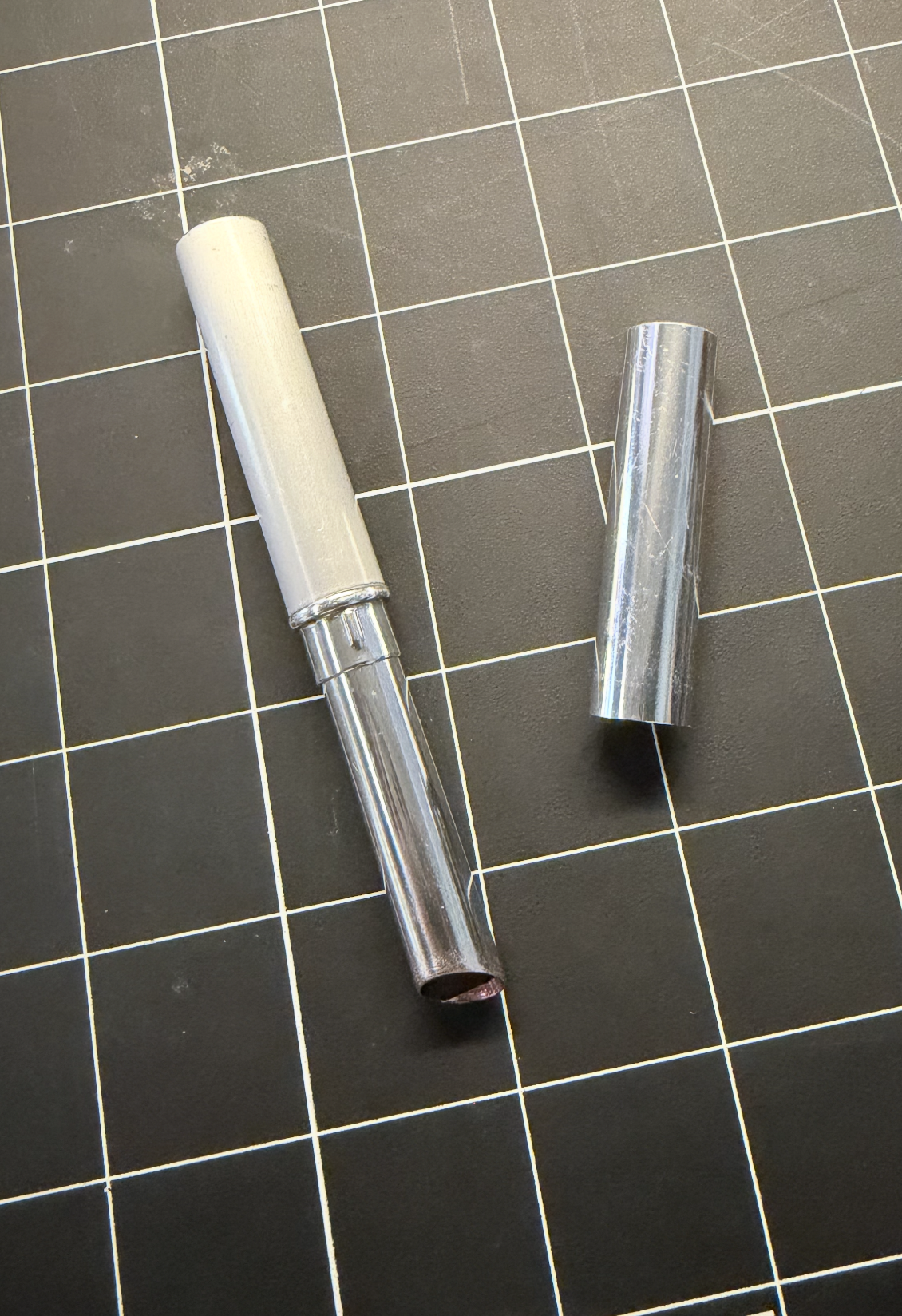 Lipstick with the cap off, front-facing.